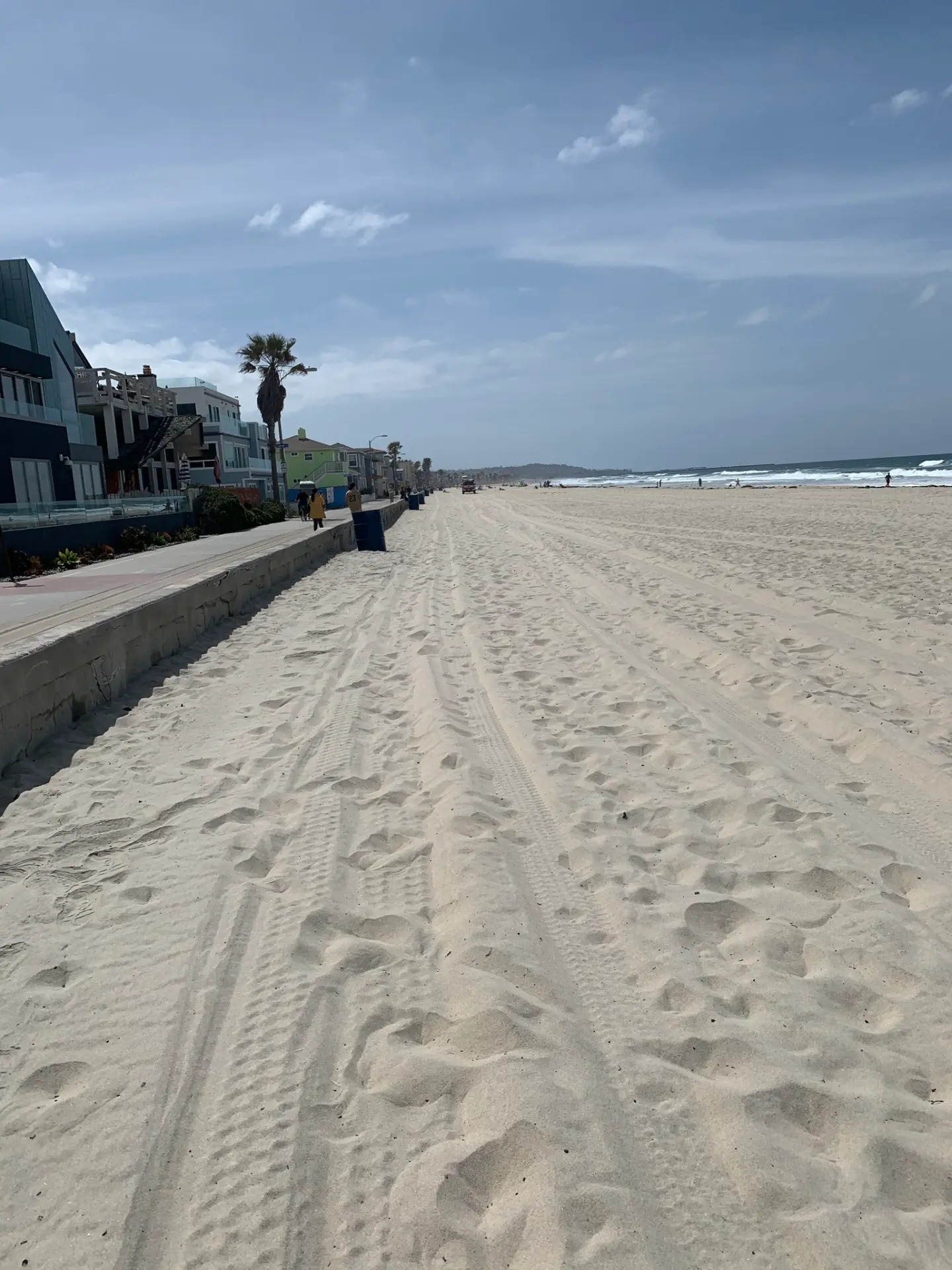 A long sandy beach path by the ocean